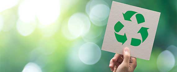 person holding recycling sign